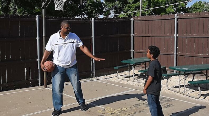 Former Kansas State big man Luis Colon, left, has finally found happiness by helping others, right here in Kansas City. At Sheffield Place on the city's east side, where Colon now works, he has taken particular interest in helping Jalin, a boy going through his own troubles as a youth. (Rich Sugg/Kansas City Star/TNS)