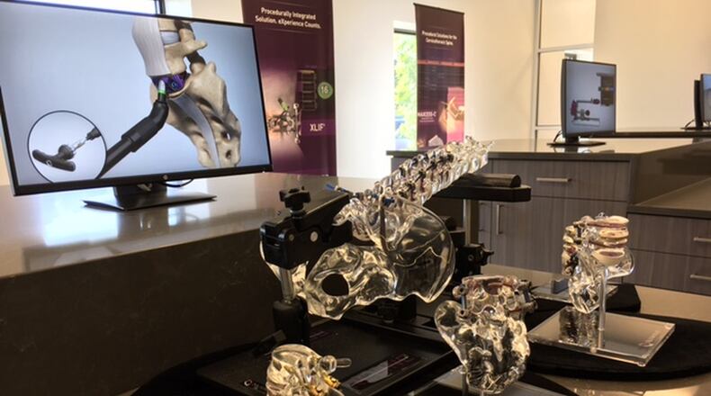 Examples of NuVasive’s products abound in the lobby of the company’s West Carrollton factory in this 2013 photo. THOMAS GNAU/STAFF