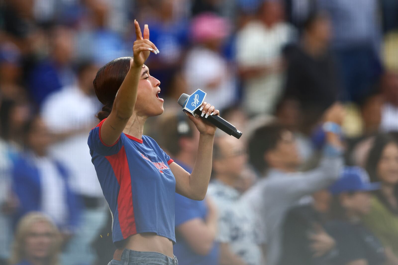 FILE - Music artist Nezza sings the national anthem prior to a baseball game between the Los Angeles Dodgers and the San Francisco Giants in Los Angeles, Saturday, June 14, 2025. (AP Photo/Jessie Alcheh,File)
