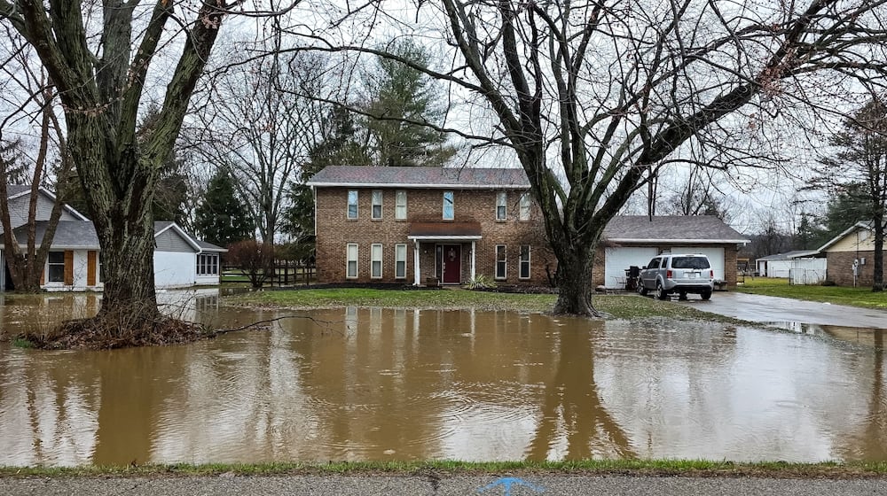 Heavy rains hit the Miami with significant flooding this week. Here is a yard flooded is Taylor School Road in Butler County. Staff Photos by Nick Graham.