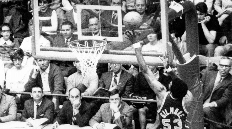 Artis Gilmore, right, grabs one of his 19 rebounds against Western Kentucky during a 1970 NCAA tournament game at the UD Arena. Defending Gilmore is Western Kentucky's Clarence Glover, 4. Dayton Daily News Archive.