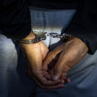 A man is detained by federal immigration enforcement agents in Rosemont, Ill., Wednesday, Dec. 17, 2025. (Ashlee Rezin/Chicago Sun-Times via AP)