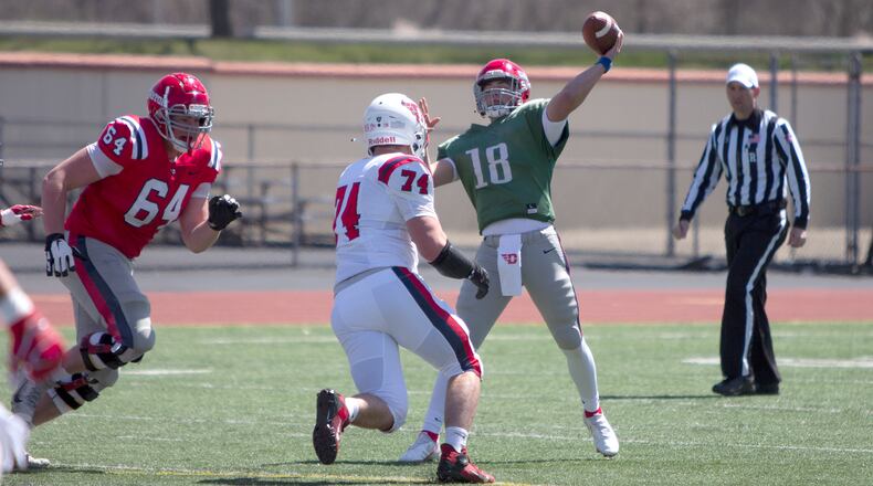 Dayton freshman quarterback Braden Woods throws downfield as redshirt freshman Sam Schadek closes in during Saturday's spring game at Welcome Stadium. Jeff Gilbert/CONTRIBUTED