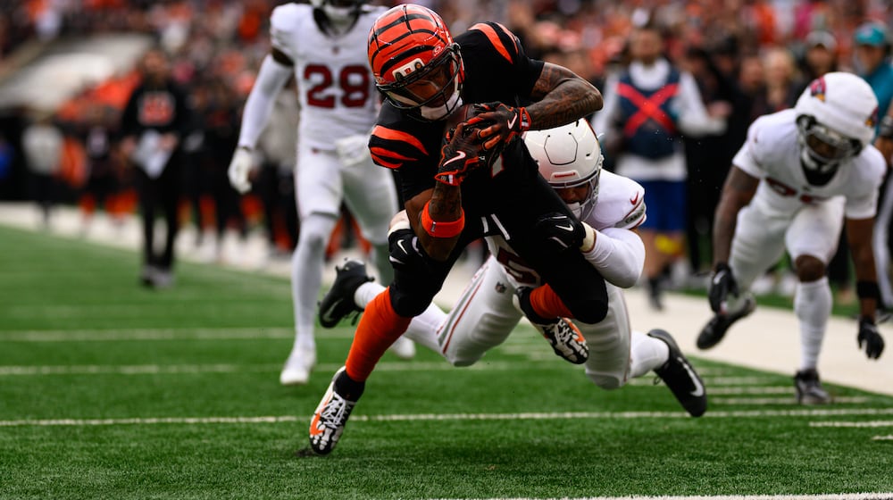 Bengals receiver Ja'Marr Chase reaches out to score a touchdown in the first quarter of their game against the Arizona Cardinals on Sunday, Dec. 28 at Paycor Stadium. JEREMY MILLER / CONTRIBUTED PHOTO