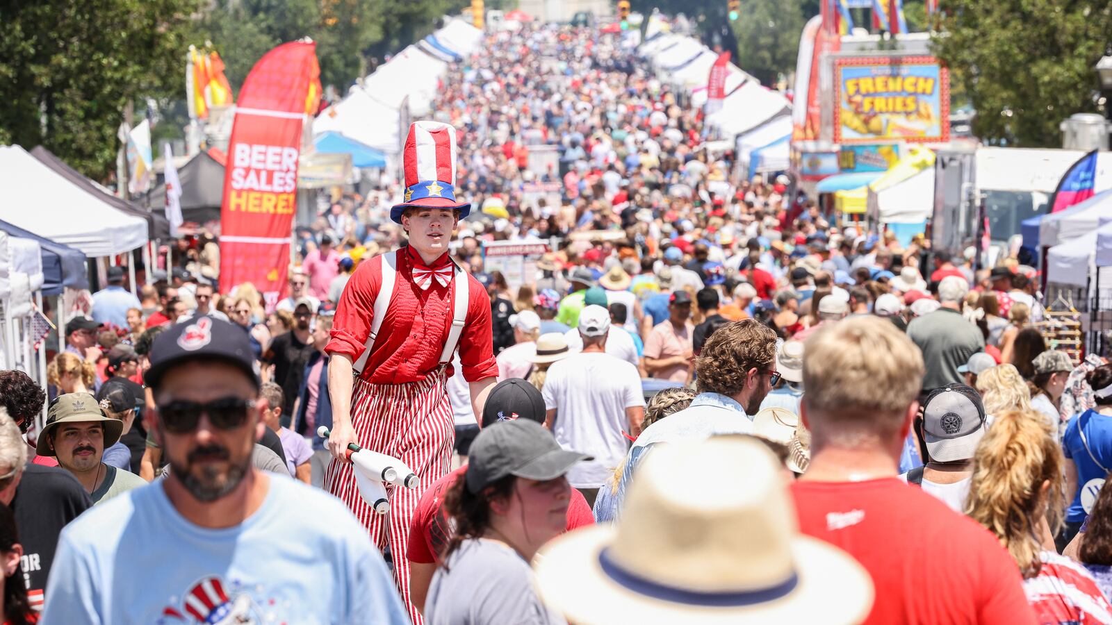 A view looking north on North Main Street as a performer in stitlts towers above the crowd during the Americana Festival on Friday, July 4 in Centerville. BRYANT BILLING / STAFF