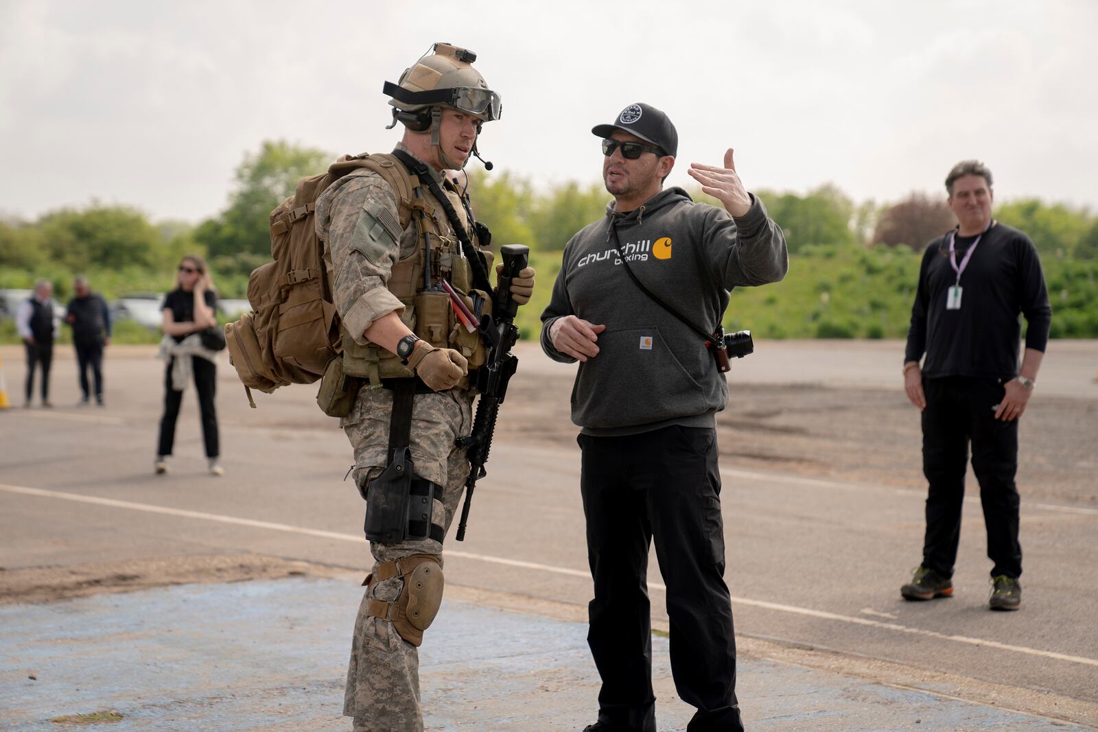 This image released by A24 shows Will Poulter, left, and Ray Mendoza on the set of "Warfare." (Murray Close/A24 via AP)