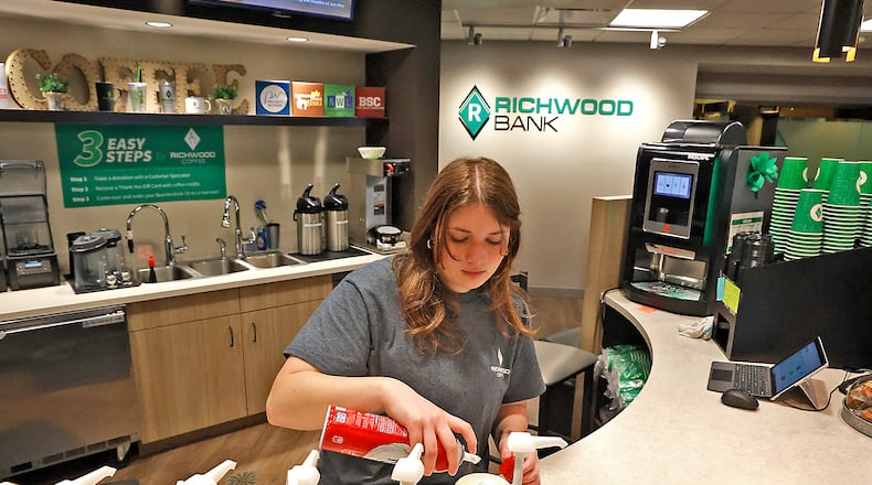 Olivia Henze makes a coffee drink at the Richwood Coffee Shop inside the Richwood Bank at 2454 North Limestone Street Monday, March 13, 2023. BILL LACKEY/STAFF