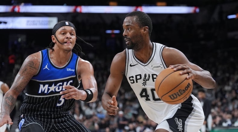San Antonio Spurs forward Harrison Barnes (40) drives against Orlando Magic forward Paolo Banchero (5) during the second half of an NBA basketball game in San Antonio, Sunday, Feb. 1, 2026. (AP Photo/Eric Gay)