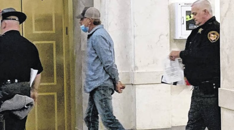 Brian Liming of Greene County is escorted by Clinton County Sheriff's deputies following his arrest Thursday on a federal warrant. JOHN HAMILTON / WiILMINGTON NEWS JOURNAL