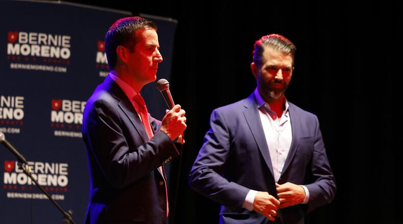 Bernie Moreno, Republican candidate for U.S. Senate, left, speaks to a crowd with Donald Trump Jr. beside him during a rally Wednesday, Feb. 28, 2024 at Lori's Roadhouse in West Chester Township. NICK GRAHAM/STAFF