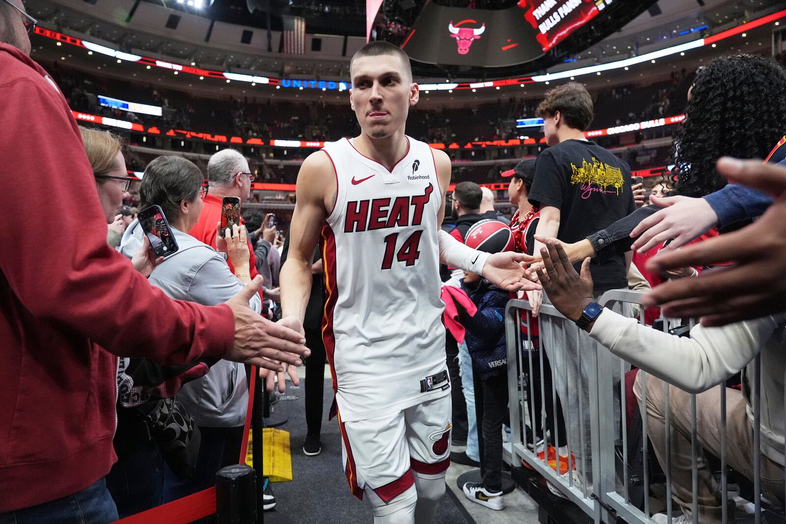 Miami Heat guard Tyler Herro celebrates with fans after the Heat defeated the Chicago Bulls in an NBA play-in tournament basketball game in Chicago, Wednesday, April 16, 2025. (AP Photo/Nam Y. Huh)
