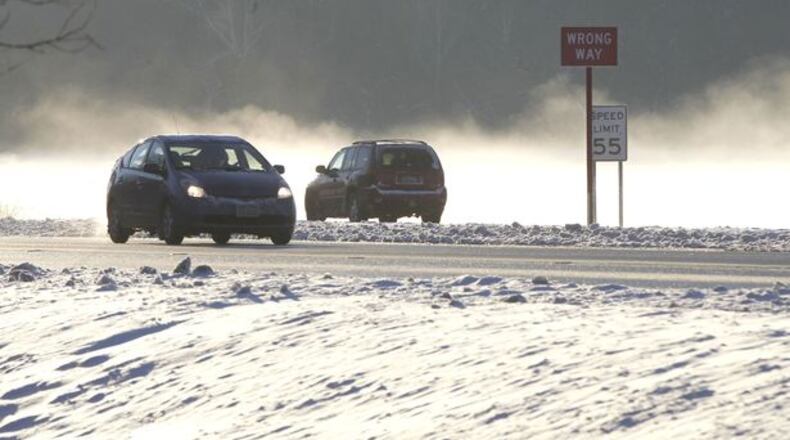 Fog from a creek near North Valley Rd. and U.S. 35 in Greene County is lit up by the morning sun on Friday when the temperatures were in the single digits. TY GREENLEES / STAFF