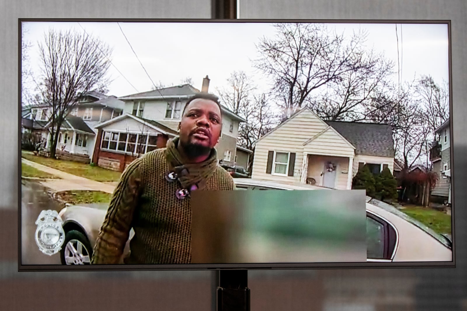 FILE - A TV display shows Patrick Lyoya as video evidence of a Grand Rapids police officer struggling with and shooting Patrick Lyoya is shown at Grand Rapids City Hall in Grand Rapids, Mich., Wednesday, April 13, 2022. (Grand Rapids Police Department via AP)