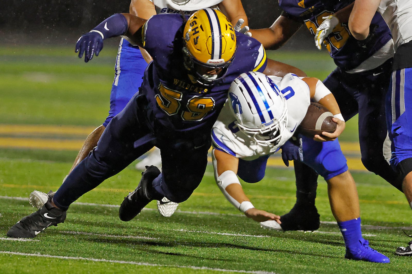 Springboro's Mattias Brunicardi is tackled by Springfield's Royce Rogers as he carries the ball. BILL LACKEY/STAFF