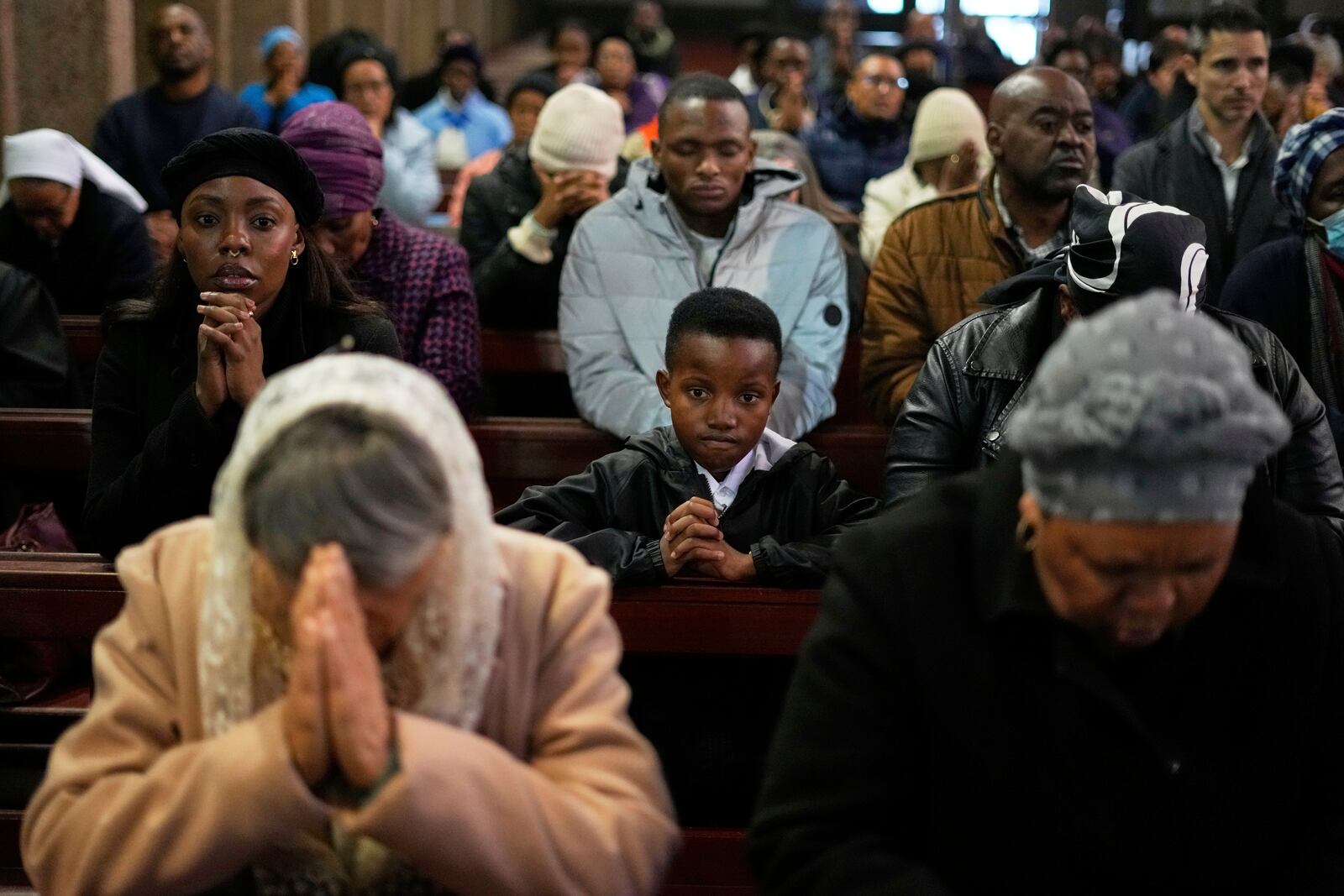 Faithfuls pray during Pope Francis Memorial Mass, at the Cathedral of Christ the King, Johannesburg, South Africa, Wednesday, April 23, 2025. (AP Photo/Themba Hadebe)