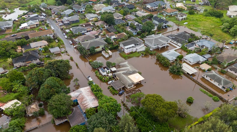 Streets are flooded from severe rains, Friday, March 20, 2026, in Haleiwa, Hawaii. (AP Photo/Mengshin Lin)