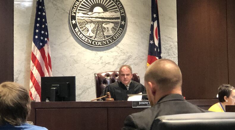 Judge Joe Kirby delayed preliminary hearings in the four juvenile cases stemming from a fatal shooting outside Lebanon in December. Kirby cited the state orders issued related to the COVID-19 pandemic. This picture was taken during the first hearing for Logan Dean, 16, of Washington Twp., Montgomery County, in Warren County Juvenile Court. Dean is sitting next to lawyer John Kaspar. STAFF/LAWRENCE BUDD