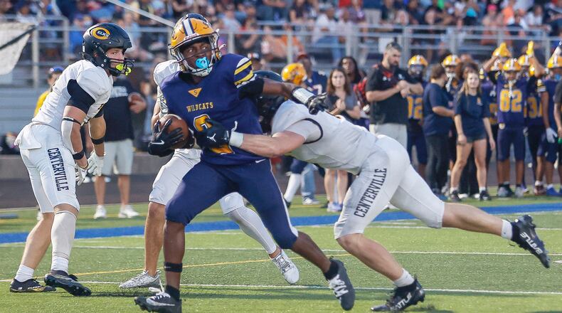 Springfield's Sherrod Lay Jr. (#2) runs toward the end zone as Centerville's AJ Taylor (#6) tries to tackle him during a game on Friday, September 19, 2025, at Springfield High School. JOSEPH COOKE/STAFF