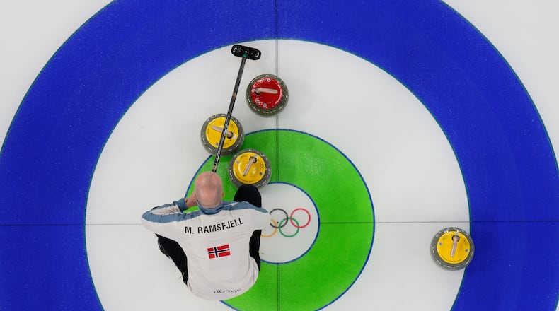 Norway's Magnus Ramsfjell looks over the stones during a men's curling round robin match against China at the 2026 Winter Olympics, in Cortina d'Ampezzo, Italy, Friday, Feb. 13, 2026. (AP Photo/David J. Phillip)
