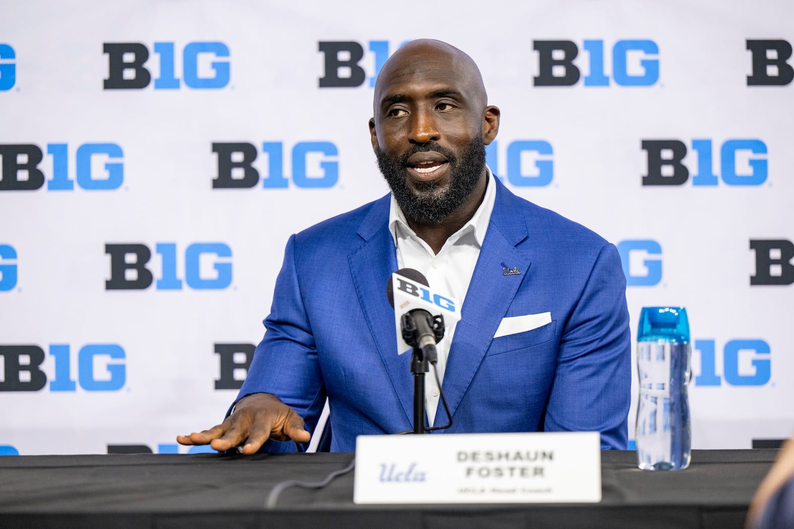 FILE - UCLA head coach DeShaun Foster talks with reporters during an NCAA college football news conference at the Big Ten Conference media days at Lucas Oil Stadium, July 24, 2024, in Indianapolis. (AP Photo/Doug McSchooler, File)