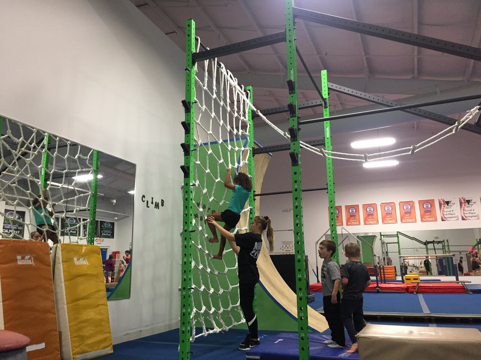 Nora Dantzler on the rope climbing wall with Coach Kassie Strahler from Kids are Tops. CONTRIBUTED
