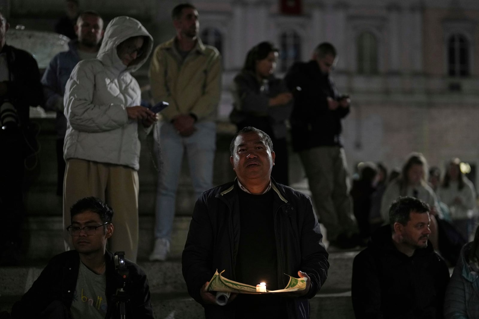 Faithful pray the rosary outside St. Mary Major Basilica, in Rome, Friday, April 25, 2025. (AP Photo/Francisco Seco)
