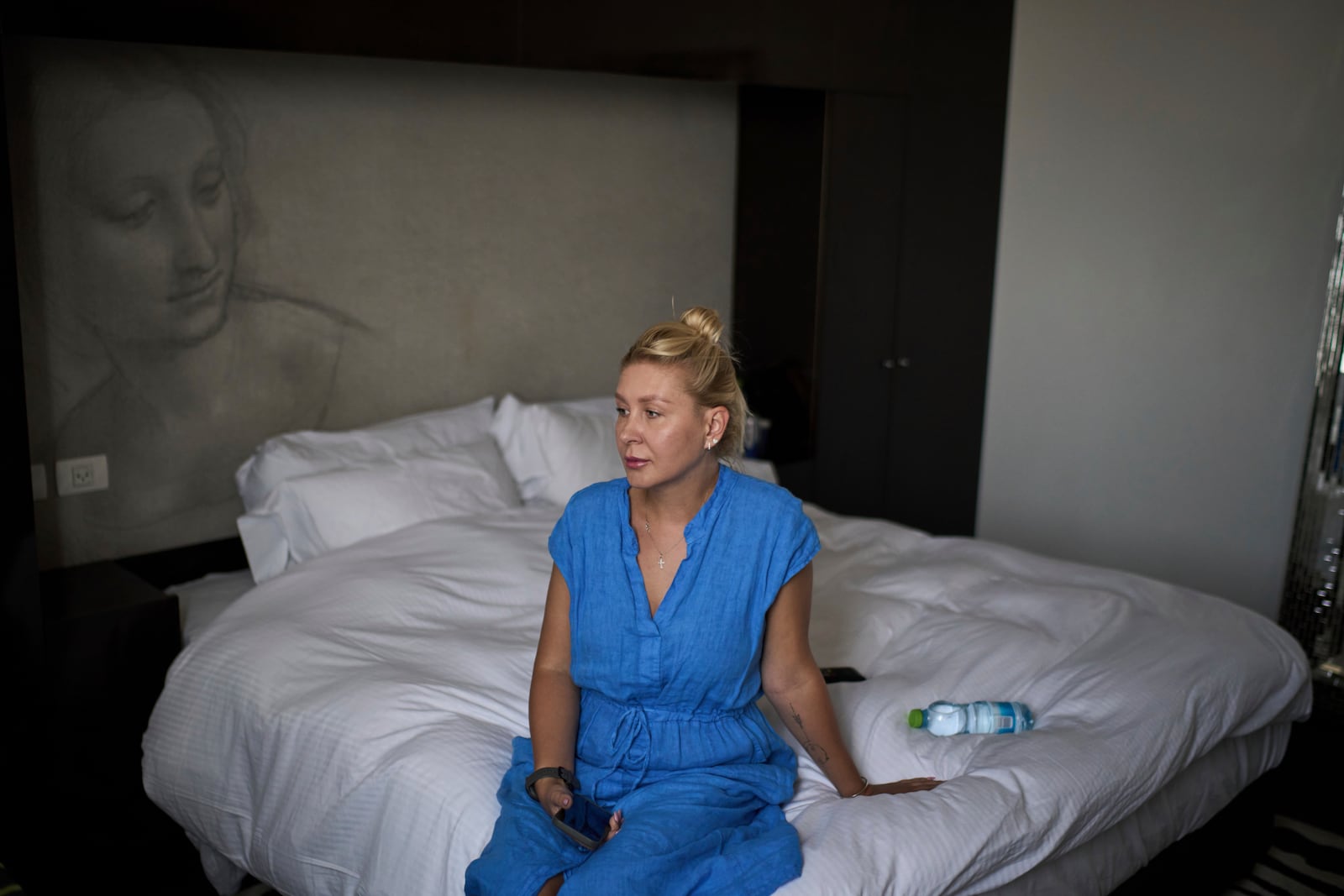 Ukrainian makeup artist Tetiana Kurakova, 40, sits in a hotel in Tel Aviv, Israel, June 17, 2025, that was turned into a shelter for evacuees from Bat Yam, which was hit by an Iranian strike. (AP Photo/Leo Correa)