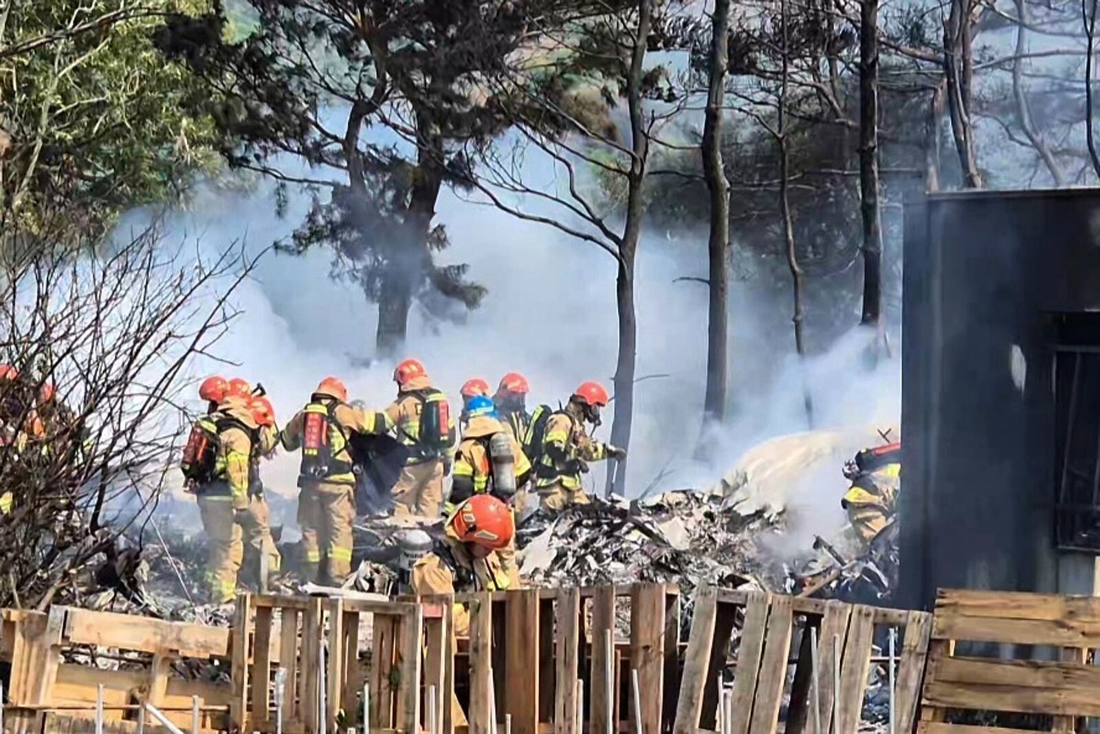 South Korean firefighters work at the scene of a South Korean navy plane's crash in Pohang, South Korea, Thursday, May 29, 2025. (Son Dae-sung/Yonhap via AP)