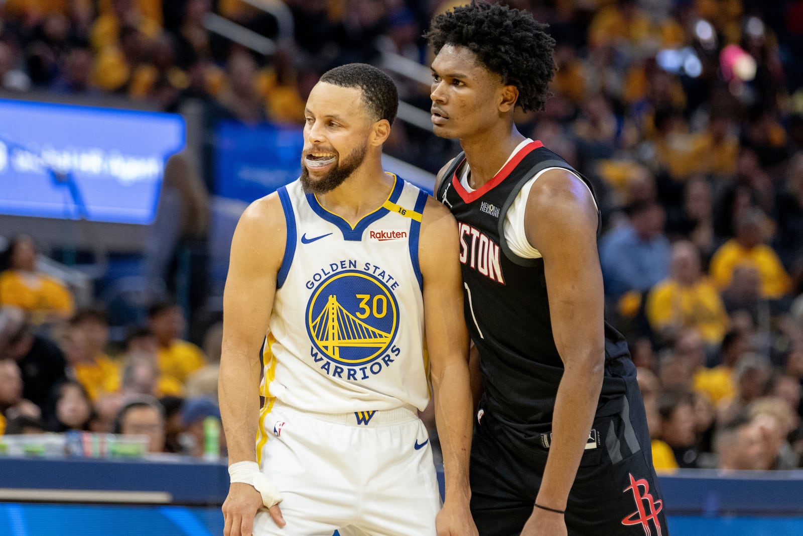 Golden State Warriors guard Stephen Curry (30) and Houston Rockets forward Amen Thompson (1) are seen during the second quarter in game 3 of the NBA Western Conference First Round in San Francisco, Saturday, April 26, 2025. (Stephen Lam/San Francisco Chronicle via AP)