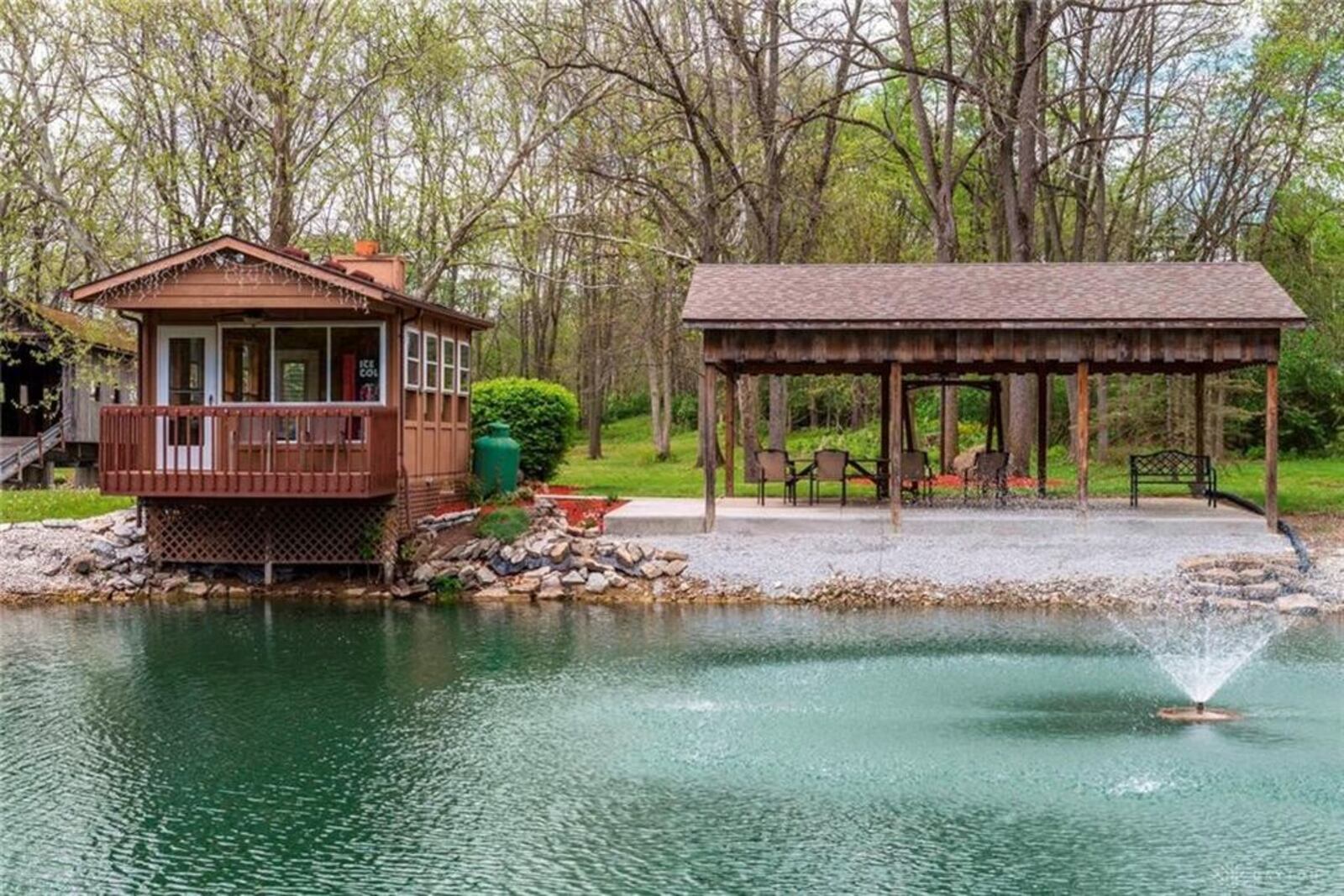 Rolling hills, a covered bridge crossing an active stream and a stocked fishing pond with picnic shelter nearby are a few of the exterior features of this property in Piqua. There is also an air-conditioned cabin with a balcony deck perfect for fishing and a barn for recreation vehicle storage. The three-story house at 9544 N. Country Club Road features a turret and balcony that allows residents to take in the views of the 9.76-acre property. Tucked back off the road along a paved driveway and backyard neighbor to the golf course, the brick-and-frame house offers 4,650 square feet of living space and is listed for $642,400 by Christine Price of Galbreath Realtors. To see other Dayton-area listed homes, visit DaytonDailyNews.com/homes. PHOTOS COURTESY OF DAYTON REALTORS.