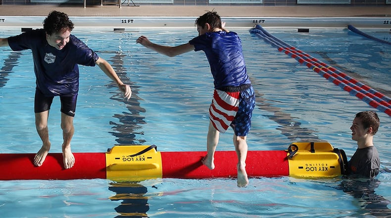 Members of the Catholic Chapel Youth Group give the sport of log rolling a try at the Dodge Gym pool, Wright-Patterson Air Force Base, Ohio, Jan. 14, 2017. Log rolling is growing in popularity across the U.S. especially in youth and collegiate aquatic programs (U.S. Air Force photo/Jim Varhegyi)
