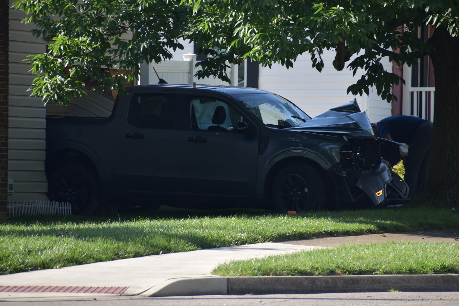 Kettering police pictured at the scene of where a vehicle apparently drove into a house on the corner of Marshall Road and Flowerdale Avenue early July 4, 2025. Police say the driver of the vehicle was deceased upon their arrival. The coroner is working on identification and notification of next of kin. SAM WILDOW/STAFF