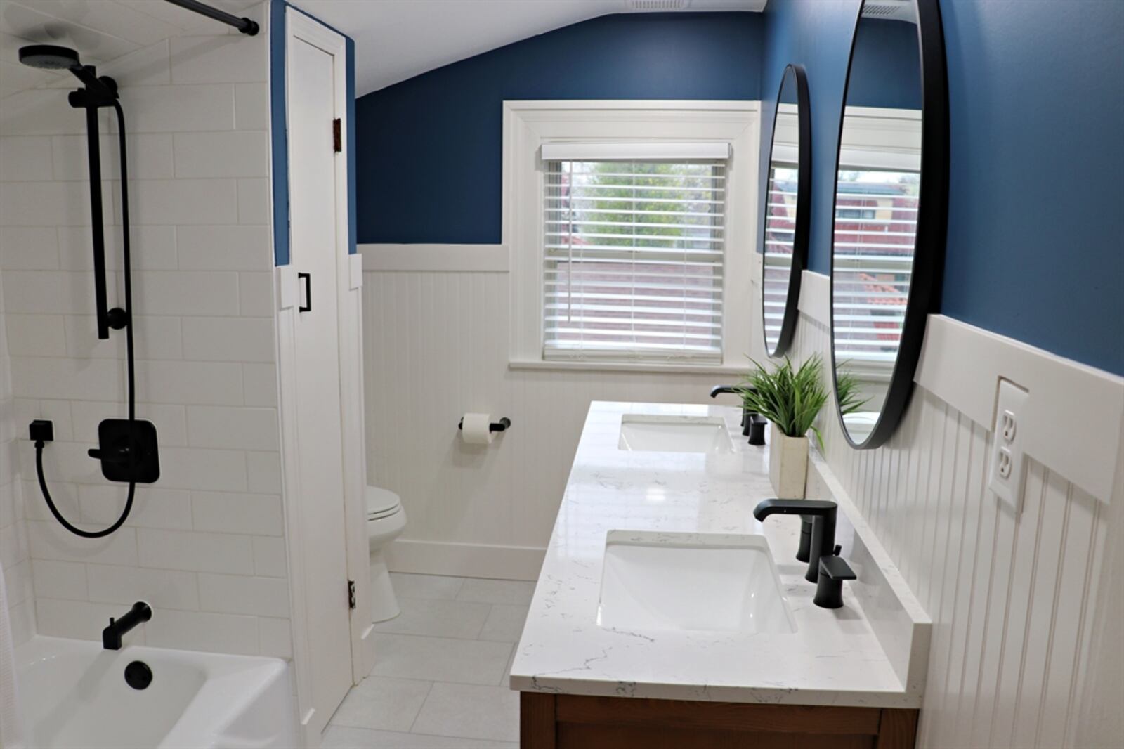 This full bathroom was remodeled in 2023 and includes a tub-shower with subway-tile surround.