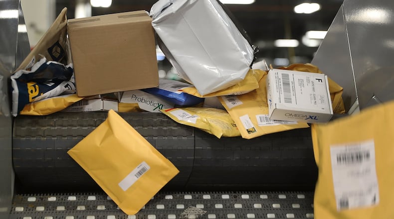 Packages advance on a conveyor belt as they are sorted at the U.S. Postal service’s Royal Palm Processing and Distribution Center on December 4, 2017 in Opa Locka, Florida. (Photo by Joe Raedle/Getty Images)