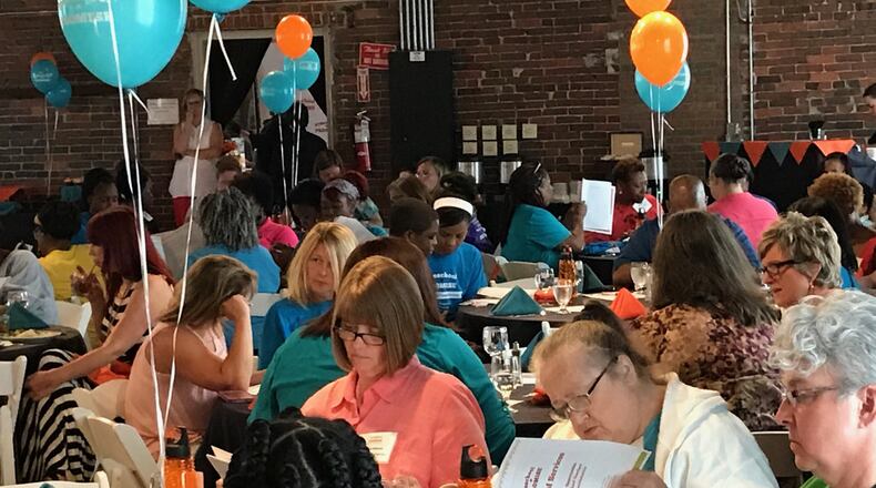 Preschool and childcare providers review the “menu of services” provided by Dayton’s Preschool Promise group at a school-year kickoff event Wednesday, July 26, at Top of the Market in Dayton. CONTRIBUTED PHOTO
