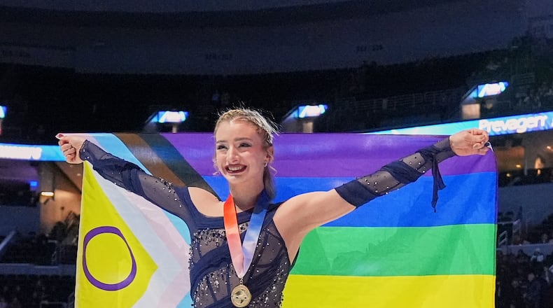 Gold medalist Amber Glenn poses with a flag after the women's free skating competition at the U.S. Figure Skating Championships, Friday, Jan. 9, 2026, in St. Louis. (AP Photo/Stephanie Scarbrough)