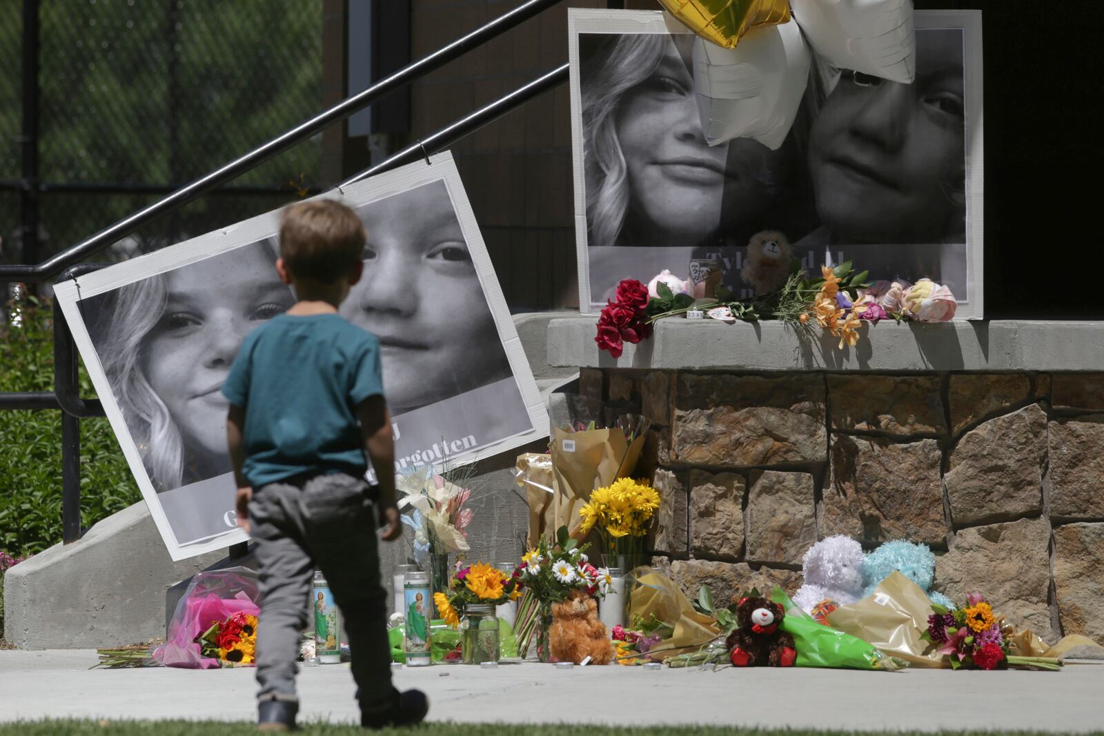 FILE - A boy looks at a memorial for Tylee Ryan and Joshua "JJ" Vallow in Rexburg, Idaho, on June 11, 2020. (John Roark/The Idaho Post-Register via AP, File)