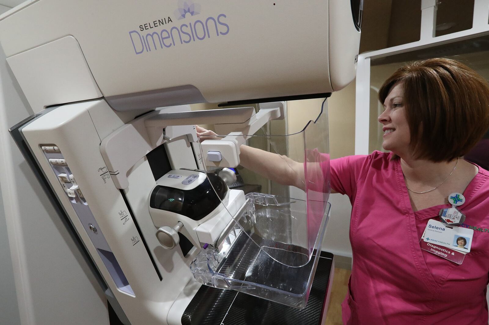 Selena Kemper, mammography supervisor, gets the 3D mammography machine ready for a patient in Mercy Health’s 3D Mobile Mammography Vehicle at the Upper Valley Mall earlier this year. BILL LACKEY/STAFF