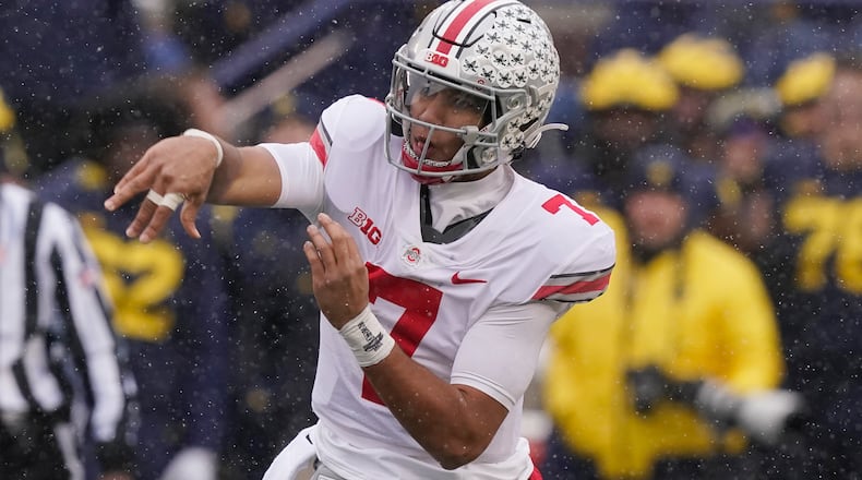 FILE - Ohio State quarterback C.J. Stroud throws during the first half of an NCAA college football game against Michigan, Saturday, Nov. 27, 2021, in Ann Arbor, Mich. The Fighting Irish open the season at No. 2 Ohio State, facing an offense that led the FBS in total yards and scoring last season and is only expected to improve in C.J. Stroud's second season as the starting quarterback. (AP Photo/Carlos Osorio, File)