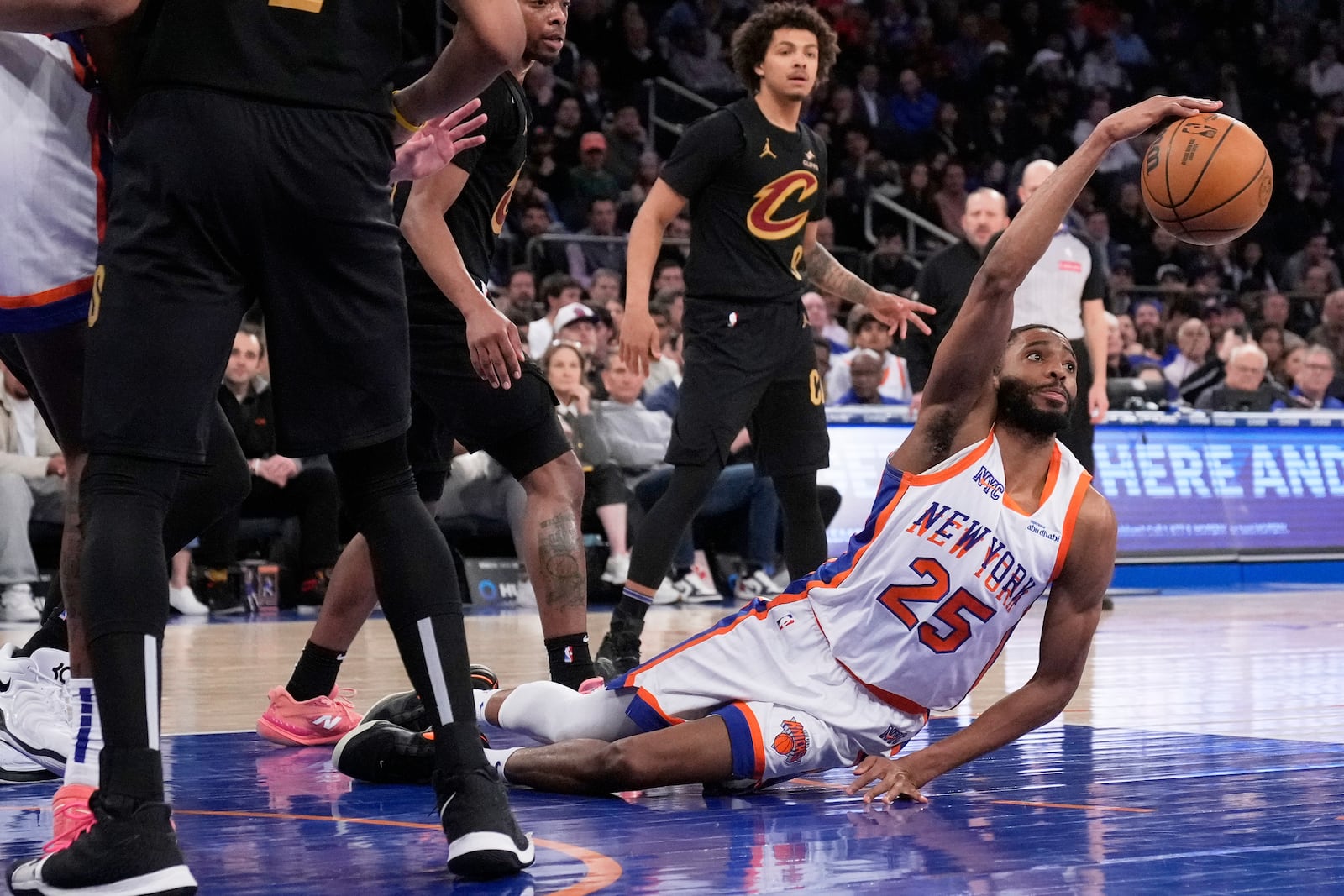 New York Knicks' Mikal Bridges (25) grabs a rebound from the floor during the second half of an NBA basketball game against the Cleveland Cavaliers Friday, April 11, 2025, in New York. (AP Photo/Seth Wenig)