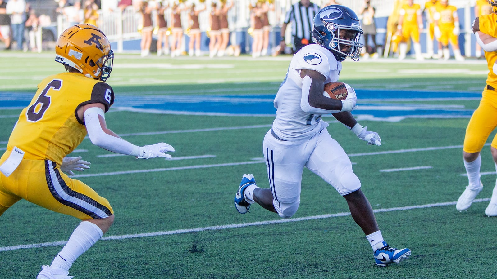 Fairmont's Damien Pattin runs through a hole and past Alter's Noah Lawson during Thursday night's 24-7 Fairmont victory. Jeff Gilbert/CONTRIBUTED