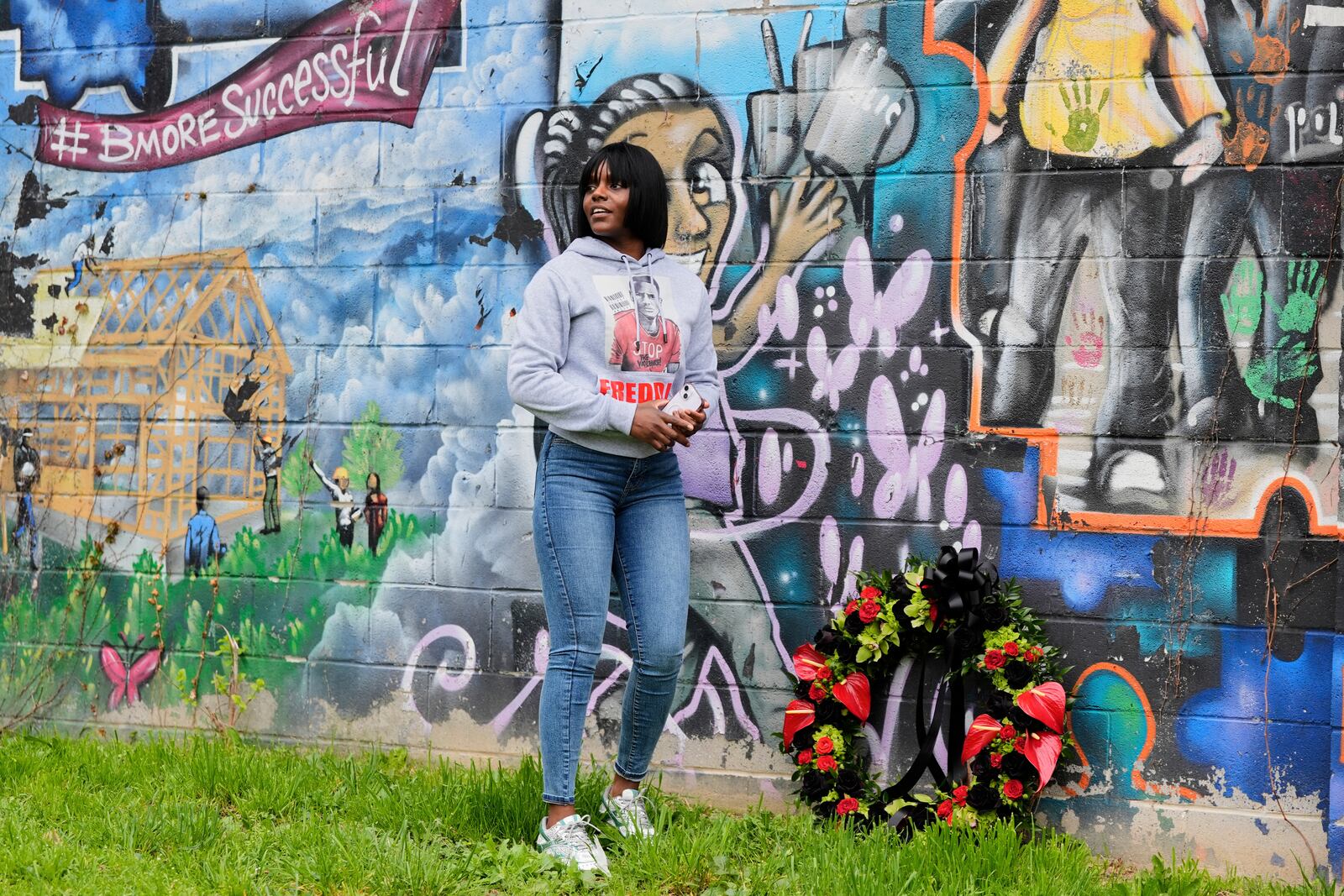 Fredricka Gray, twin sister of Freddie Gray, lays a wreath at a mural during a memorial event commemorating the ten-year anniversary of her brother's death, Saturday, April 19, 2025, in Baltimore. (AP Photo/Stephanie Scarbrough)