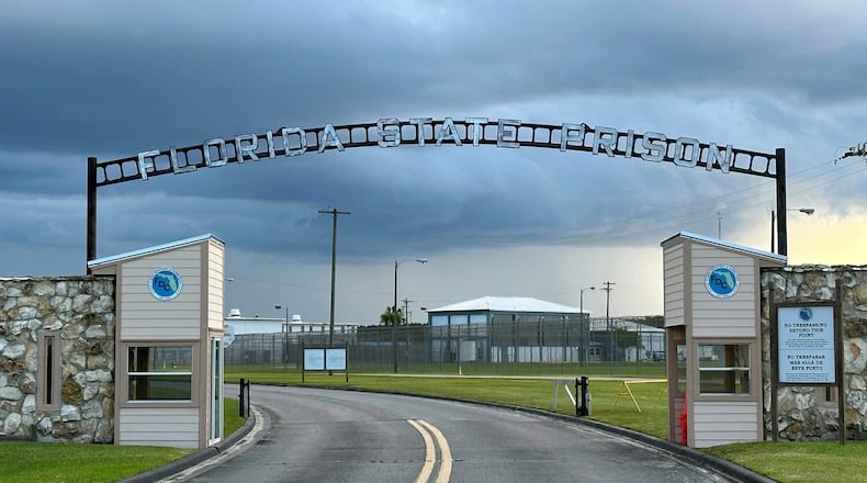 FILE - Clouds hover over the entrance of the Florida State Prison in Starke, Fla., Aug. 3, 2023. (AP Photo/Curt Anderson, File)