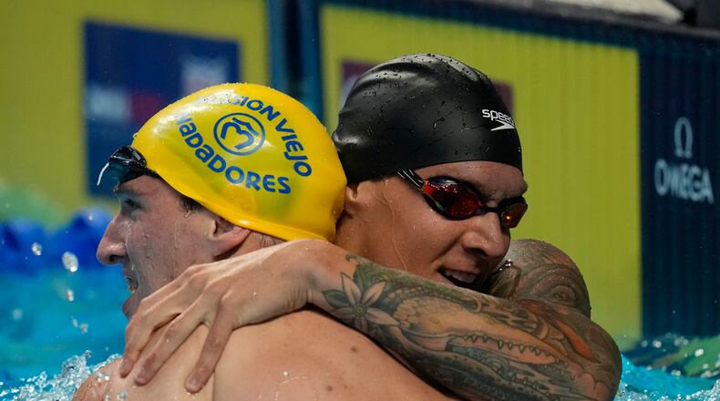 Caeleb Dressel hugs Zach Apple after winning the men's 100 freestyle during wave 2 of the U.S. Olympic Swim Trials on Thursday, June 17, 2021, in Omaha, Neb. (AP Photo/Charlie Neibergall)
