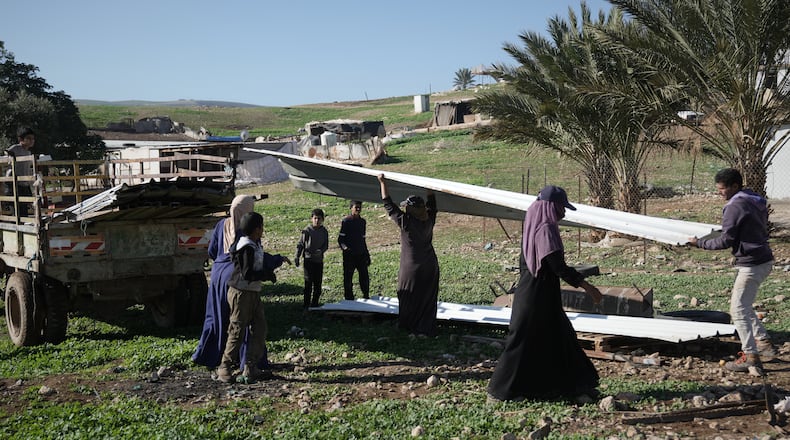 Palestinian residents of Ras Ein al-Auja village, West Bank pack up their belongings and prepare to leave their homes after deciding to flee mounting settler violence, Sunday, Jan. 11, 2026. (AP Photo/Mahmoud Illean)