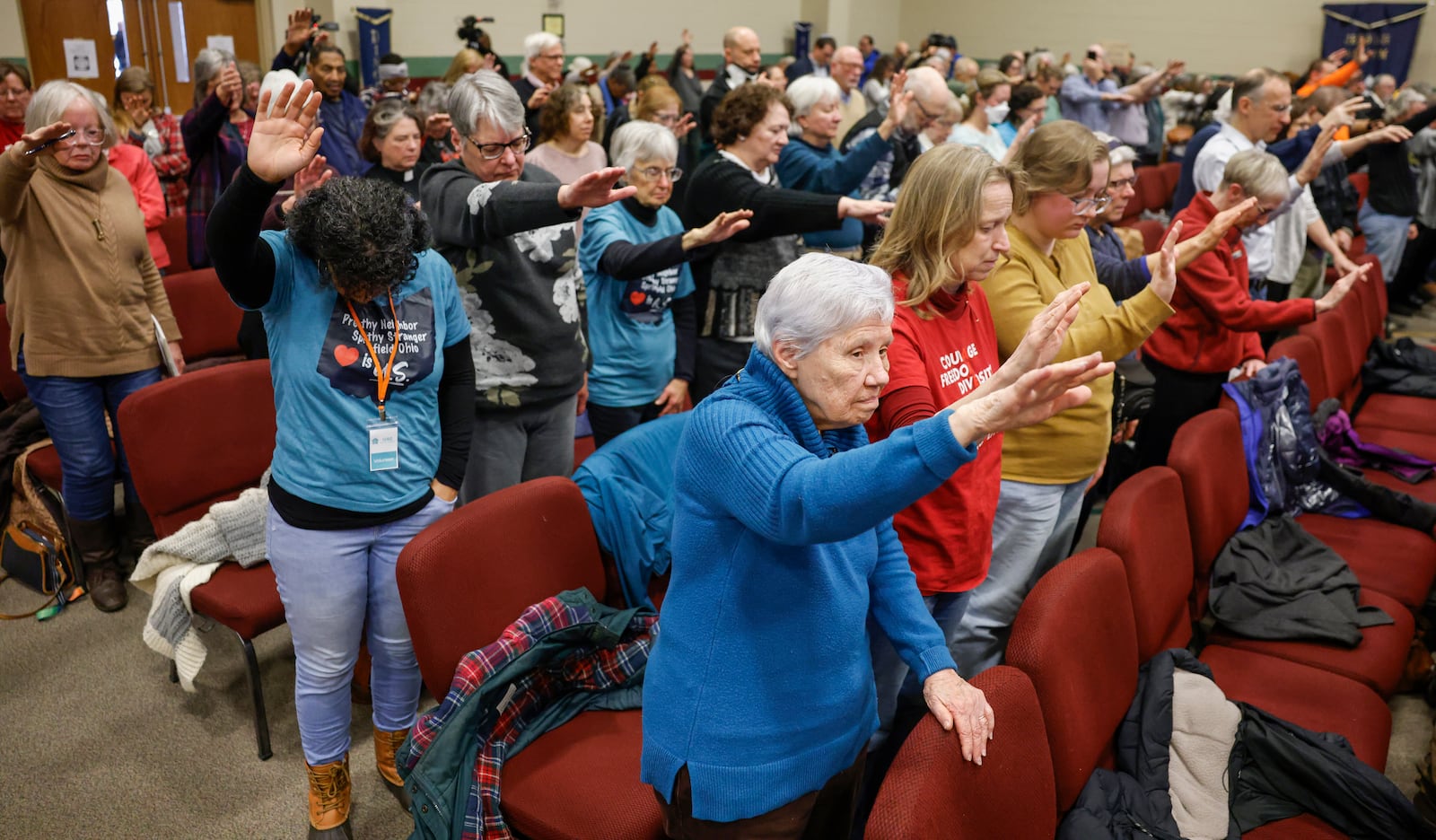 Audience members hold their hands up in prayer during Here We Stand: Faith Leaders for Immigration Justice & Family Unity at St. John Missionary Baptist Church on Monday, Feb. 2, 2026, in Springfield. Pastors, faith leaders and community members gathered to pray and call for the extension of Temporary Protected Status which is scheduled to expire on Tuesday, Feb. 3, 2026. JOSEPH COOKE/STAFF