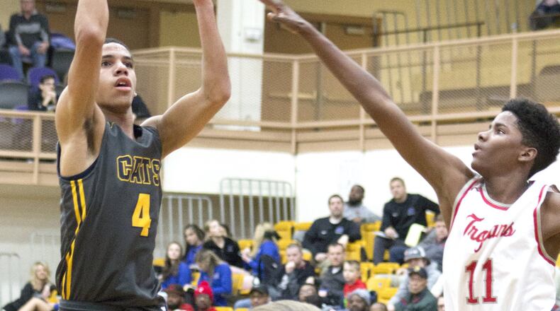 Springfield’s David Sanford shoots over Troy’s Tre’Vone Archie during the Wildcats’ 67-43 victory in a second-round sectional game Thursday night at Vandalia Butler. Sanford made three 3-pointers and scored 13 points. Jeff Gilbert/CONTRIBUTED