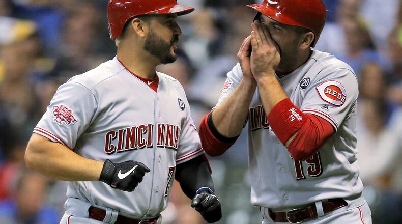 MILWAUKEE, WISCONSIN - JULY 22: Eugenio Suarez #7 and Joey Votto #19 of the Cincinnati Reds celebrate after Suarez hit a home run in the seventh inning against the Milwaukee Brewers at Miller Park on July 22, 2019 in Milwaukee, Wisconsin. (Photo by Dylan Buell/Getty Images)