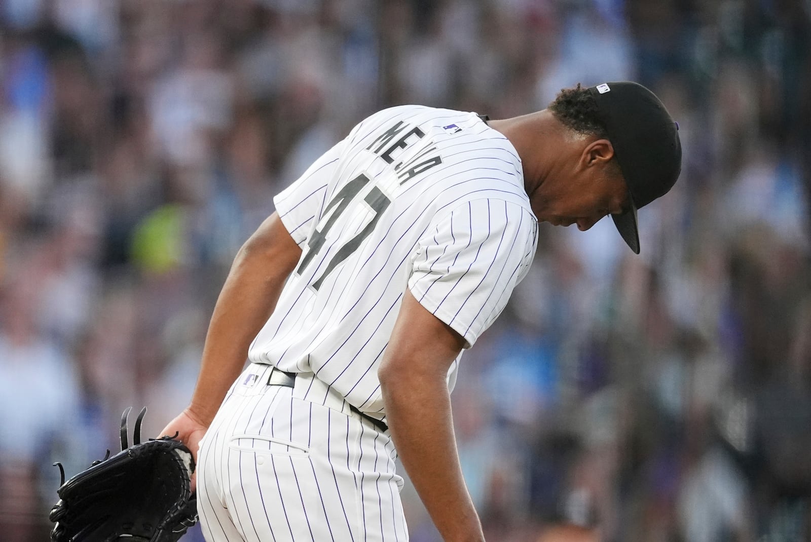 Colorado Rockies relief pitcher Juan Mejia reacts after giving up a three-run home run to San Diego Padres' Fernando Tatis Jr. in the fifth inning of a baseball game Saturday, May 10, 2025, in Denver. (AP Photo/David Zalubowski)