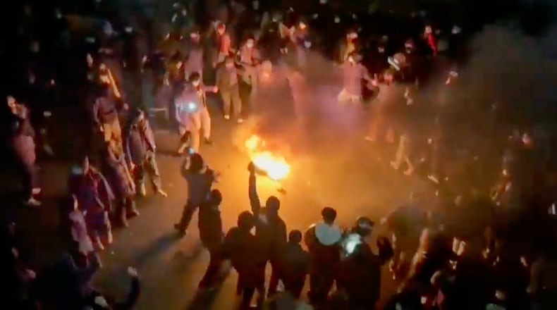 In this frame grab from footage circulating on social media shows protesters dancing and cheering around a bonfire as they take to the streets despite an intensifying crackdown as the Islamic Republic remains cut off from the rest of the world, in Tehran, Iran, Friday, Jan. 9, 2026.(UGC via AP)